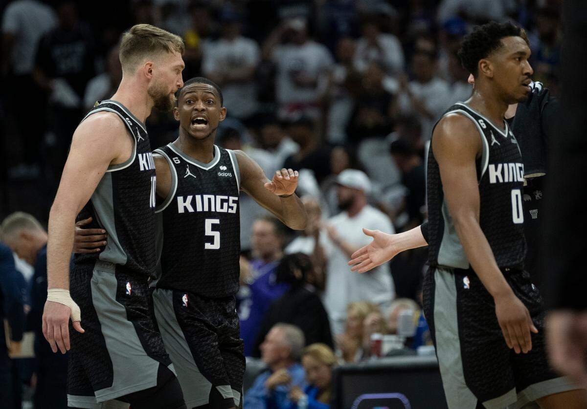 The Sacramento Kings’ Domantas Sabonis (10) and guard De’Aaron Fox (5) walk to the bench during Game 1 of the first-round NBA playoff series at Golden 1 Center on Saturday, April 15, 2023.