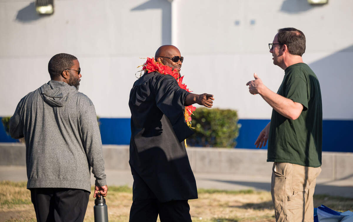 Grant Union High School Principal Darris Hinson, center, arrives before the school’s graduation ceremony Thursday, June 1, 2023, in Sacramento’s Del Paso Heights neighborhood.