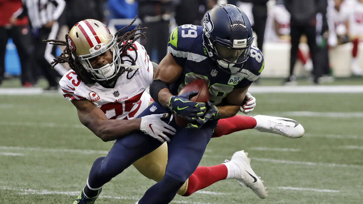 49ers cornerback Richard Sherman, left, tries to tackle Seattle Seahawks wide receiver Doug Baldwin on Dec. 2 in Seattle. Sherman is in his first season with the 49ers after spending the first seven seasons with the Seahawks. The teams play Sunday at Levi’s Stadium.