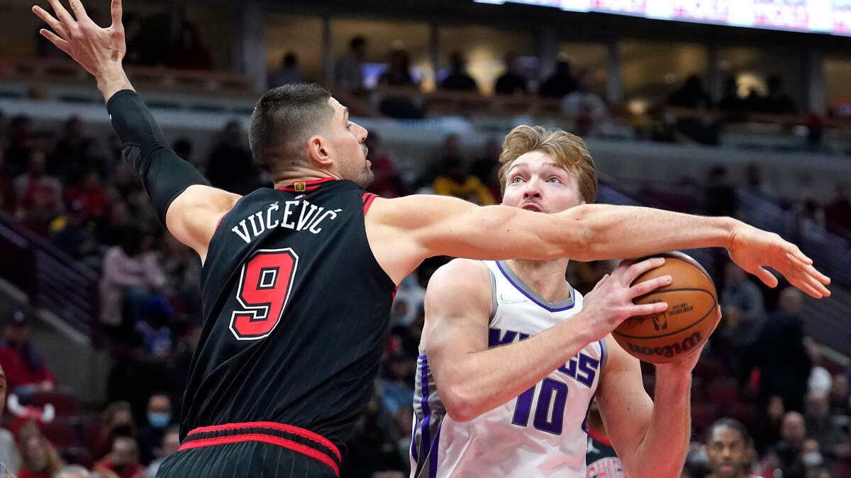 Chicago Bulls’ Nikola Vucevic (9) pressures Sacramento Kings’ Domantas Sabonis during the first half of an NBA basketball game Wednesday, Feb. 16, 2022, in Chicago. (AP Photo/Charles Rex Arbogast)