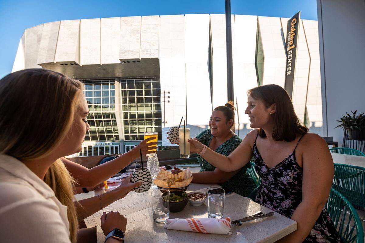 “We just went wedding dress shopping,” recently engaged Sacramento resident Hailey Wright, right, said while sitting with her friends on a patio at Polanco across from Golden 1 Center on Thursday. She was toasting with her friends, sitting counter-clockwise: Megan Williams, who now lives in Woodland; Rita Dawson, visiting from San Antonio; and Haley Cameron of Sacramento. “I go all the time,” Wright said about attending Sacramento Kings games. “I live really close, so I usually just walk here with my fiancé.”
