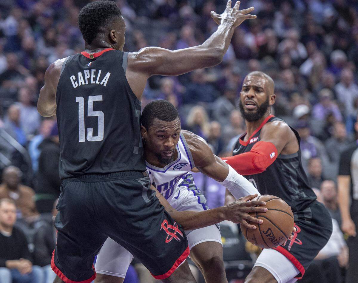 Sacramento Kings forward Harrison Barnes (40) attempts to drive against the Houston Rockets center Clint Capela (15) to the basket at the Golden 1 Center on Tuesday, April 2, 2019 in Sacramento, Calif.