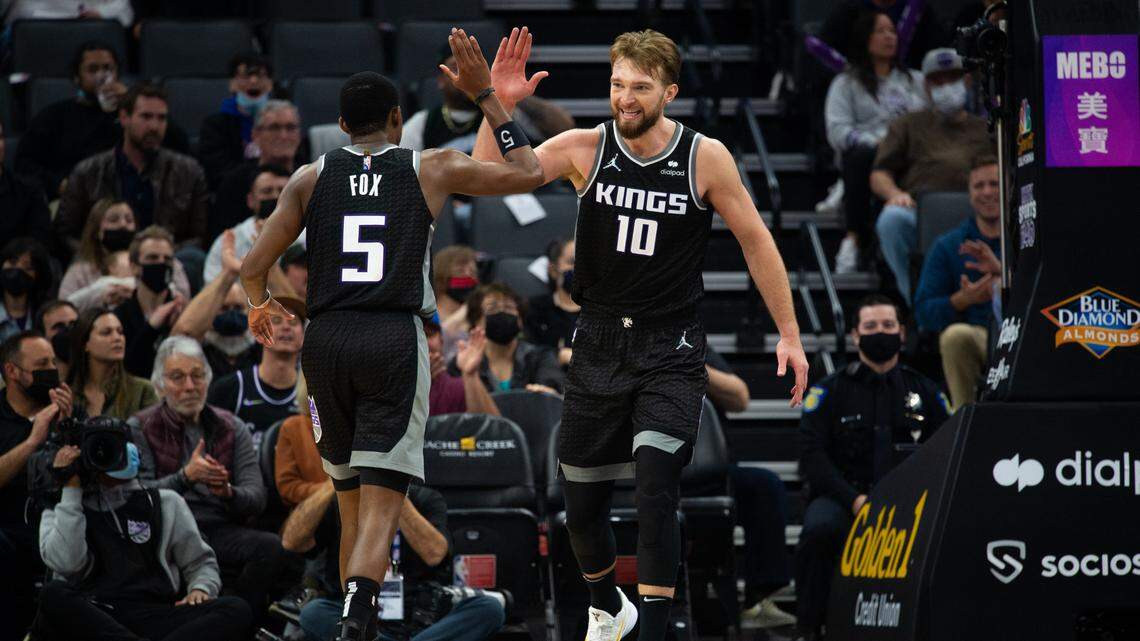 Sacramento Kings center Domantas Sabonis (13) and Sacramento Kings guard De’Aaron Fox (5) reacts after basket in the fourth quarter during a game at Golden 1 Center on Wednesday, Feb. 9, 2022 in Sacramento.