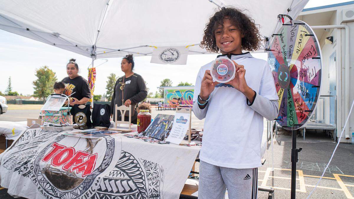 TOFA ambassador Ian Folau sells custom-branded “Krazy Kandy” at a school fair on June 9, 2023. The program gave him the confidence to run for his school council, he said.