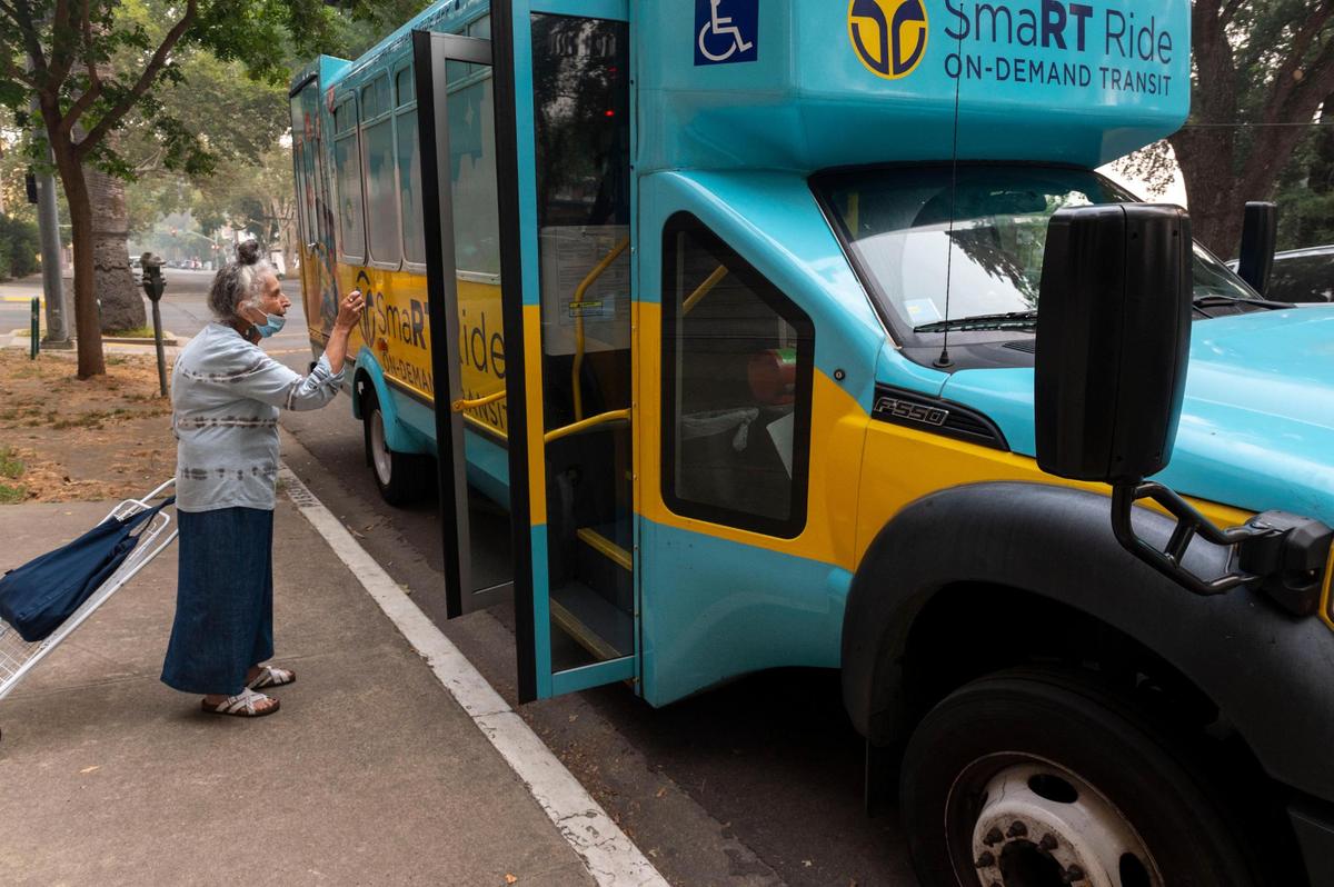 Rosalie Rashid, 81, shows her Connect bus pass, with money loaded onto it, to get on the SmaRT Ride on-demand service bus on Friday, Sept. 11, 2020. Rashid, who only travels by public transportation, started using their on-demand service during COVID because she feels it is safer and more direct.