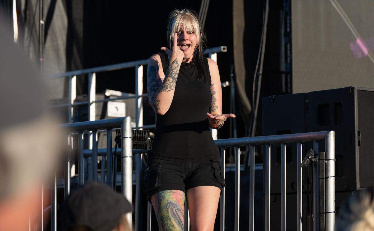 An ASL interpreter signs the lyrics for rock bank Seether at the Aftershock festival in Sacramento’s Discovery Park on Sunday. The festival provides services for the deaf and hard of hearing at its two largest stages.