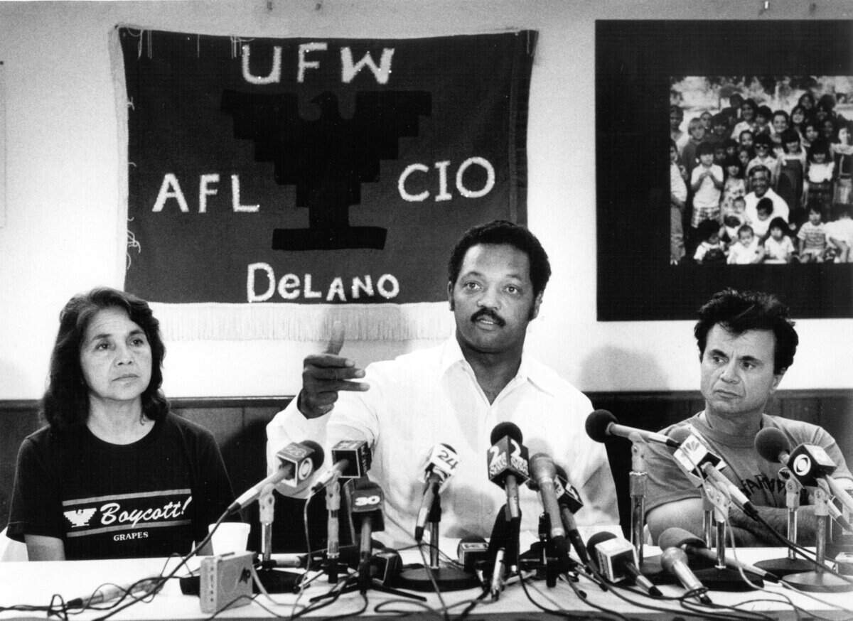 Rev. Jesse Jackson speaks during a news conference in August 1988 in Delano on the 29th day of a water-only fast by labor leader Cesar Chavez. Jackson is flanked by Dolores Huerta, vice president of the United Farm Workers, and actor Robert Blake.