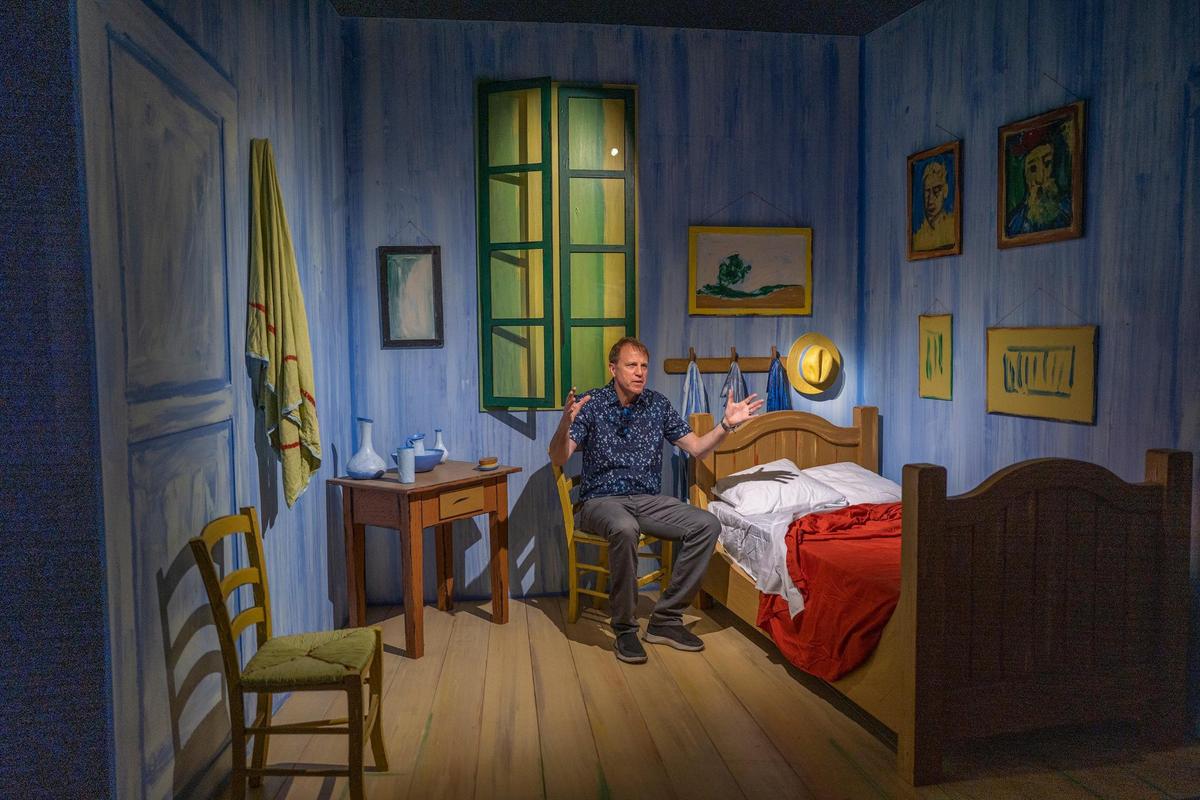 John Zaller, executive producer of the exhibition hub, sits in a replica of Van Gogh’s bedroom at the Van Gogh Immersive Experience in West Sacramento on Tuesday.