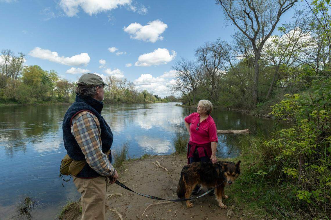 William Avery and Nancy Kniskern stands along the bank of the American River in an area know as Pirates Cove or Loon Lagoon on Thursday, March 28, 2024 in Sacramento. Kniskern and  Avery are trying to protect the American River Parkway from the upcoming construction project to be impacted by flood control work that they think is overkill.