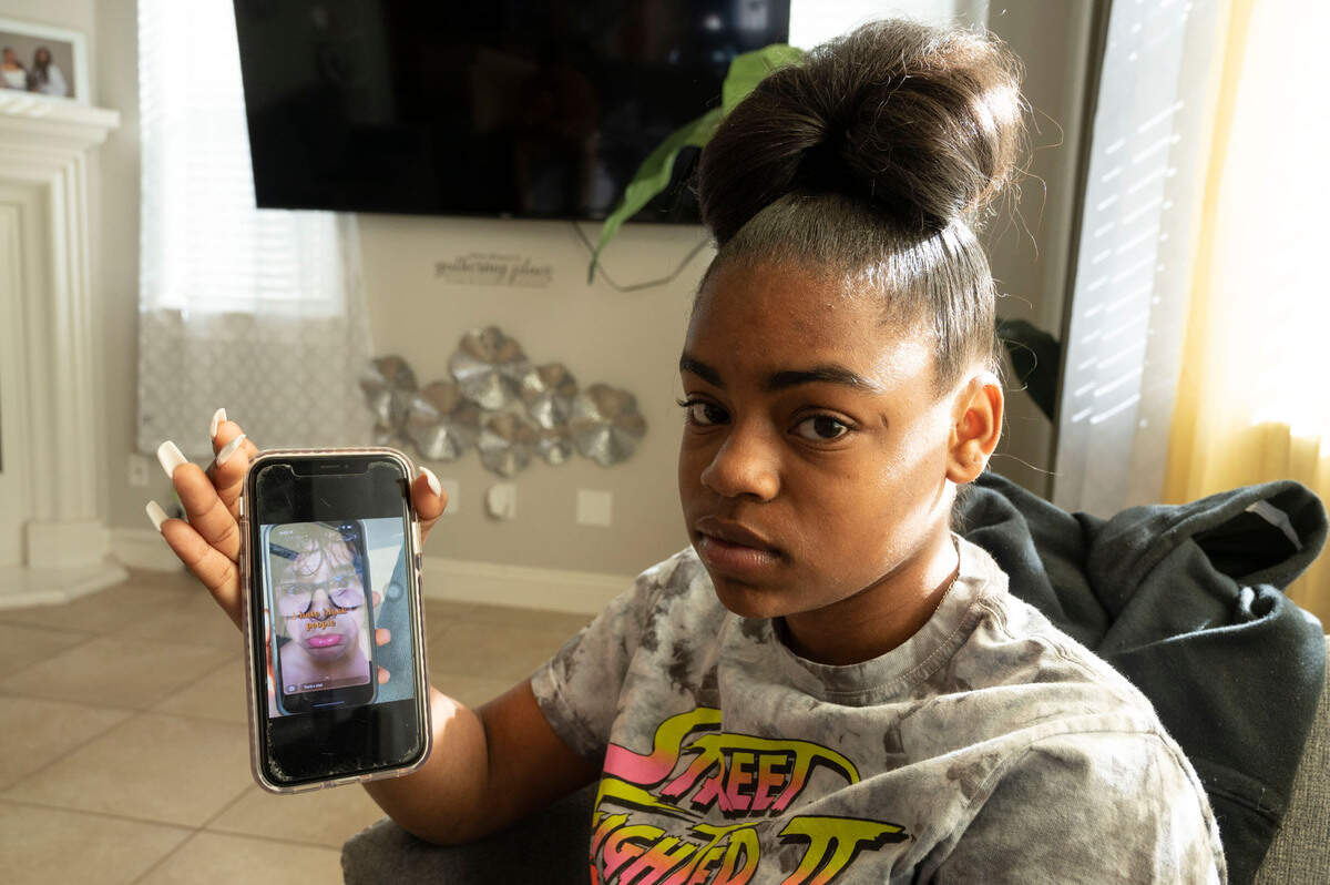 Folsom High School freshman Aniyha Pier, 15, holds her phone Friday showing a social media post from a classmate that reads “I hate Black people”. She said she has been subject to bullying and racist comments since October 2021.