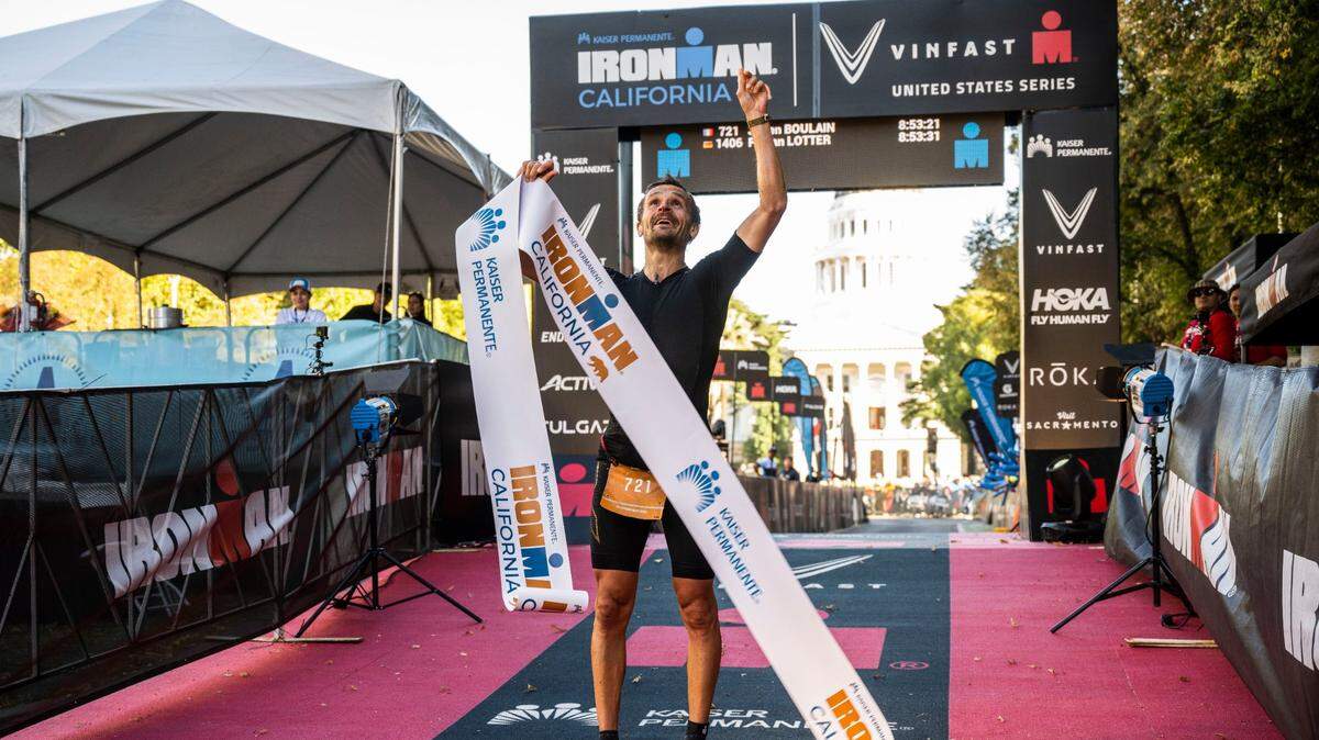 Julien Boulain of Paris, France, points to the sky in October after finishing in first place in the men’s category of the Ironman California triathlon in Sacramento.
