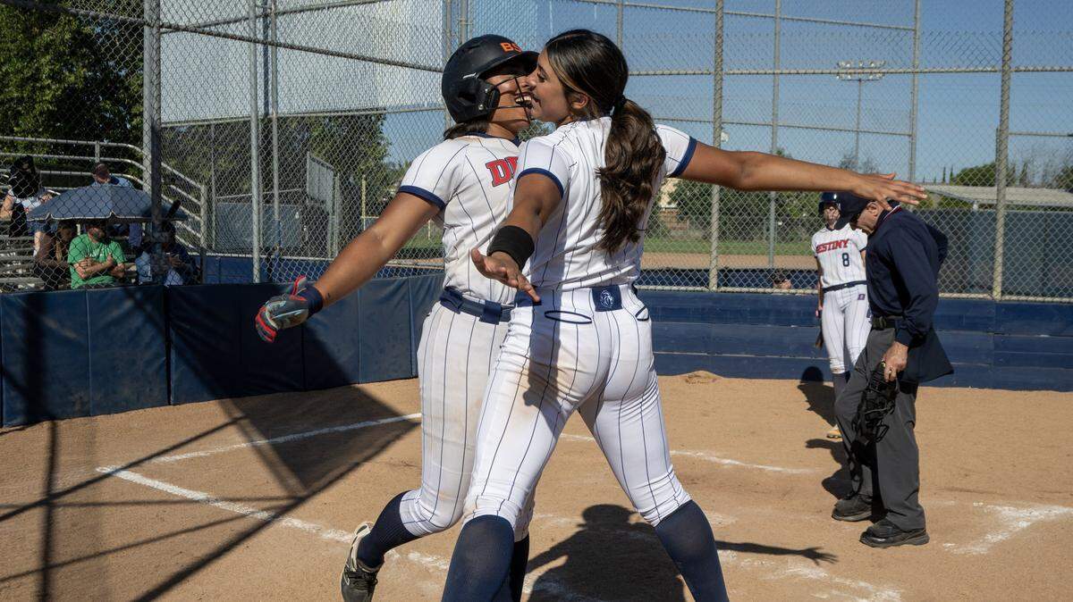 The Destiny Christian Lions’ hitter Ayla Tuua (19) celebrates with Mia Jimenez (9) after hitting a grand slam home run in the fourth inning against the El Camino Eagles at Destiny Christian in Rancho Cordova on Wednesday, April 29, 2026,