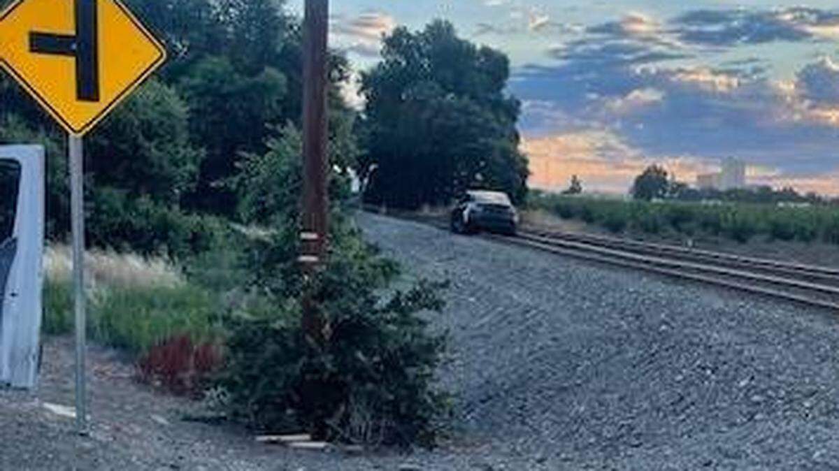A Tesla is stuck on the train tracks Wednesday morning. Woodland police said the vehicle’s autopilot mistook the rail road for the street.