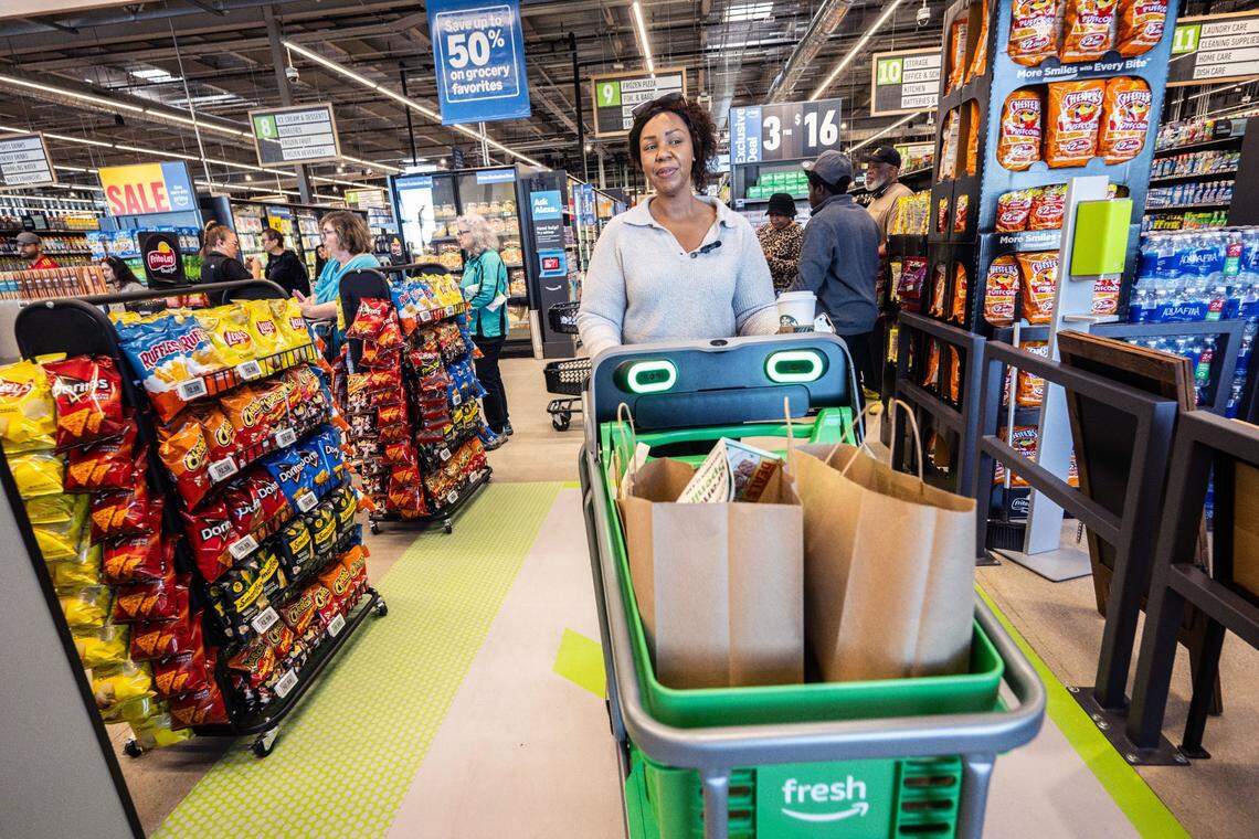 Elk Grove resident Natasha Mosley-Simpkins exits the newly opened Amazon Fresh store in Elk Grove on Thursday, Sept. 12, 2024, after using an Amazon Dash Cart to bypass traditional checkout lines. Amazon announced Tuesday it will close all Amazon Fresh stores, including the Elk Grove location.