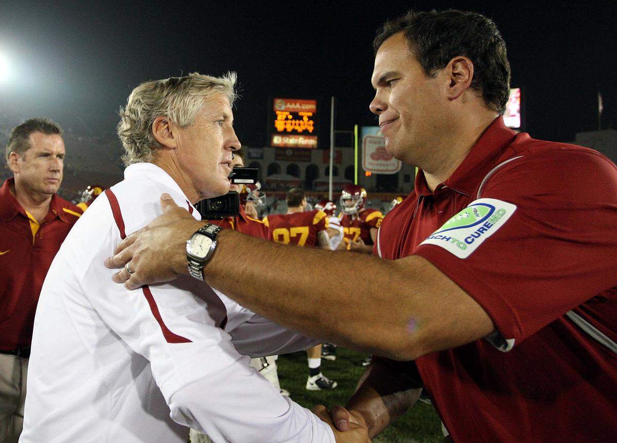 USC Trojans head coach Pete Carroll, left, shakes hands with Washington State Cougars head coach Paul Wulff after USC won 27-6 at the Los Angeles Memorial Coliseum in 2009.