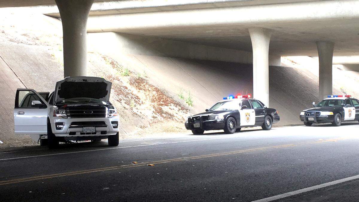 A Ford SUV sits on the side of San Juan Road after Sacramento Police performed a vehicle intervention technique in 2019, bringing an end to a pursuit that reached 100 mph and lasted more than half an hour.