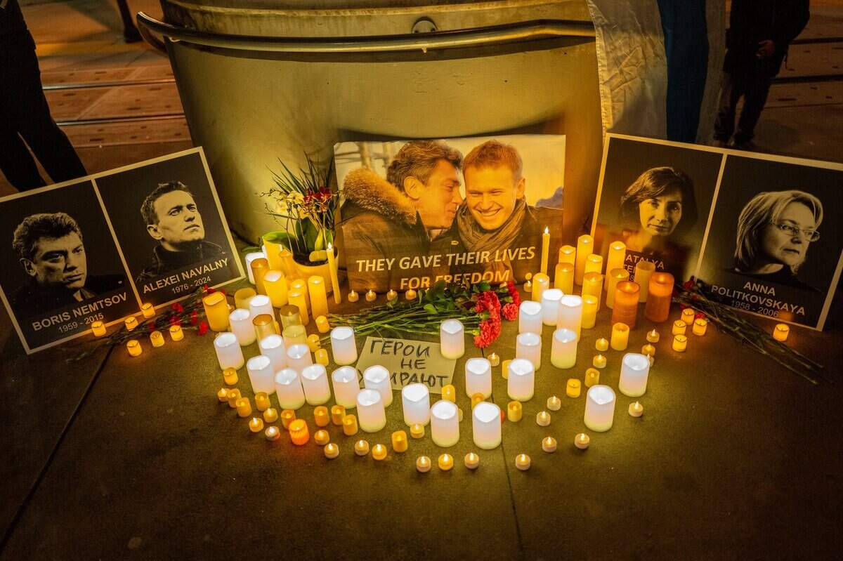 Candles illuminate photographs of Russian opposition leaders, including Alexei Navalny, who died in an Arctic penal colony earlier this month, and Boris Nemtsov, who was murdered on a Moscow bridge in 2015, during a vigil near the Tower Bridge in Sacramento on Tuesday.