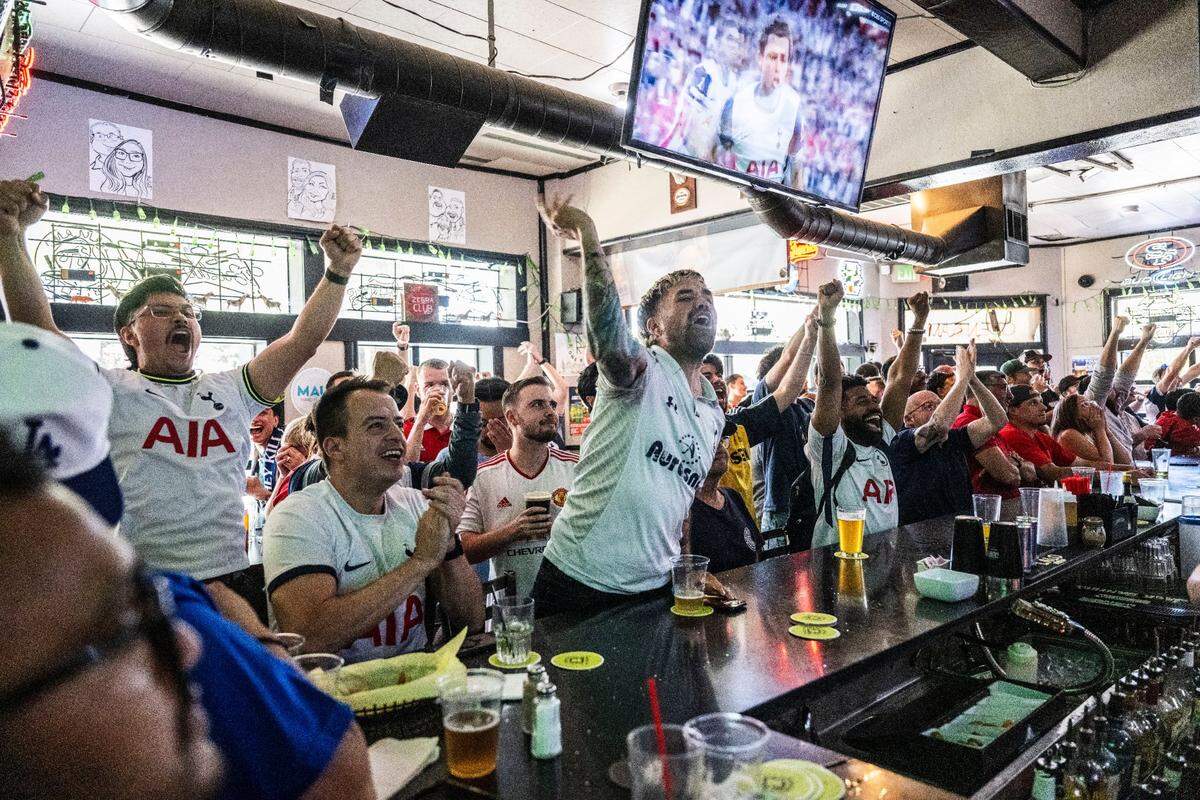 Sacramento resident Zac Zavala, center, celebrates with other Tottenham fans as they watch the Europa League championship broadcast against Manchester United on Wednesday at the Zebra Club in Sacramento.