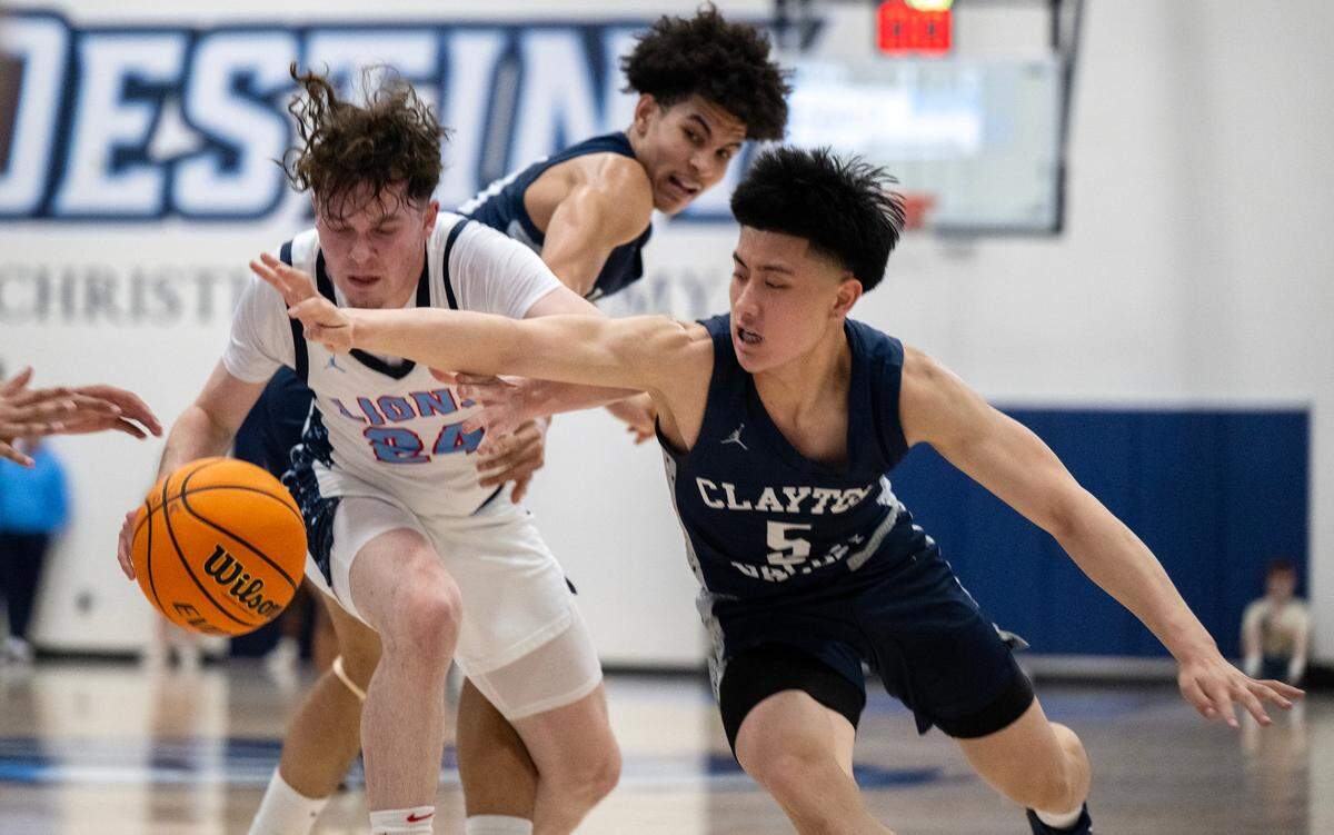 The Destiny Christian Lions’ Jaylen Valdez (24) and the Clayton Valley Charter Ugly Eagles’ Jett Tran (5) battle for a loose ball in the first half of the CIF Northern California Division Il semifinal game on Saturday.