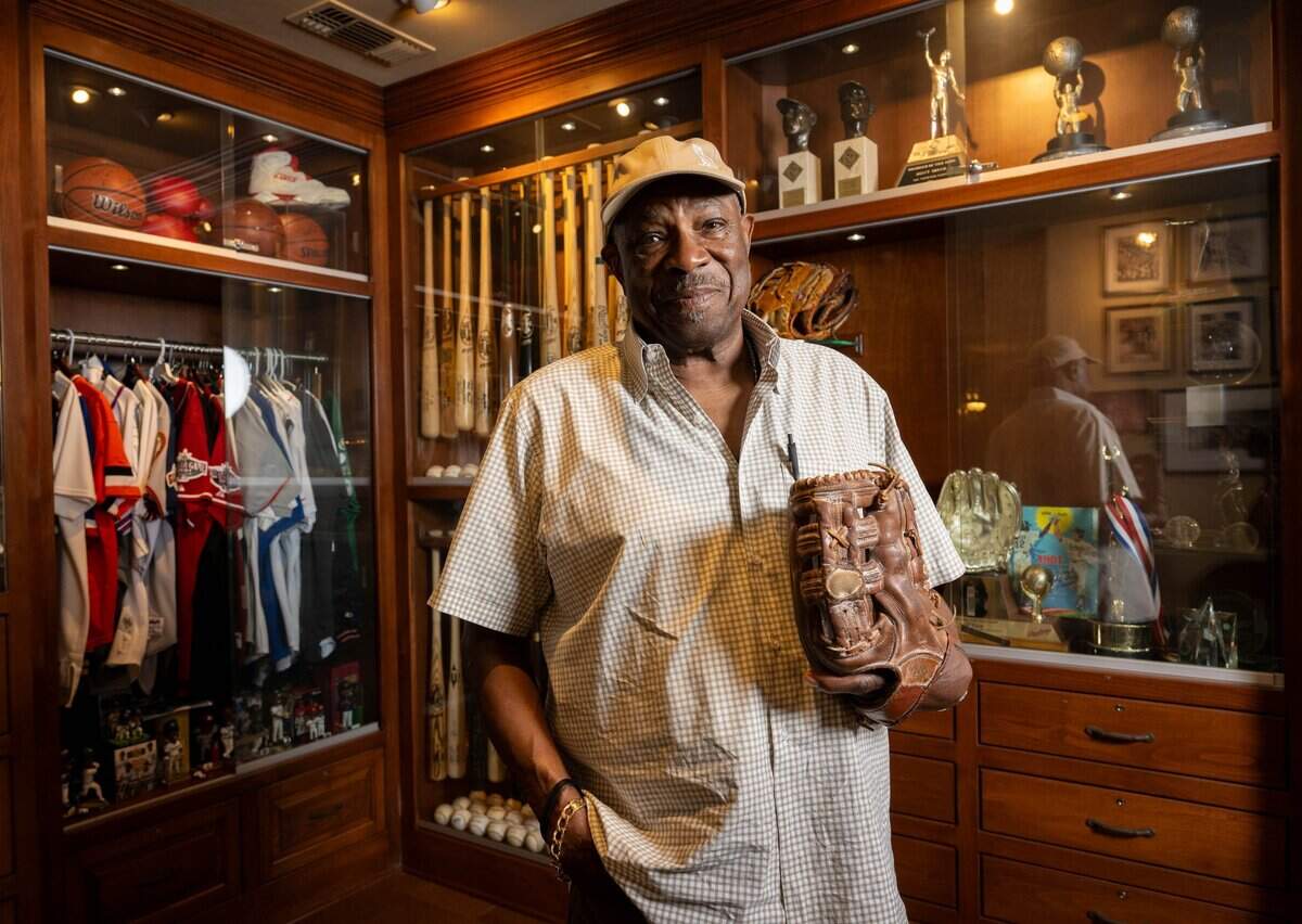 Dusty Baker wears the baseball glove he used during his playing career with the Los Angeles Dodgers, San Francisco Giants and Oakland Athletics at his Granite Bay home on Wednesday. Baker's his new memoir, "Crossroads," comes out later this month.