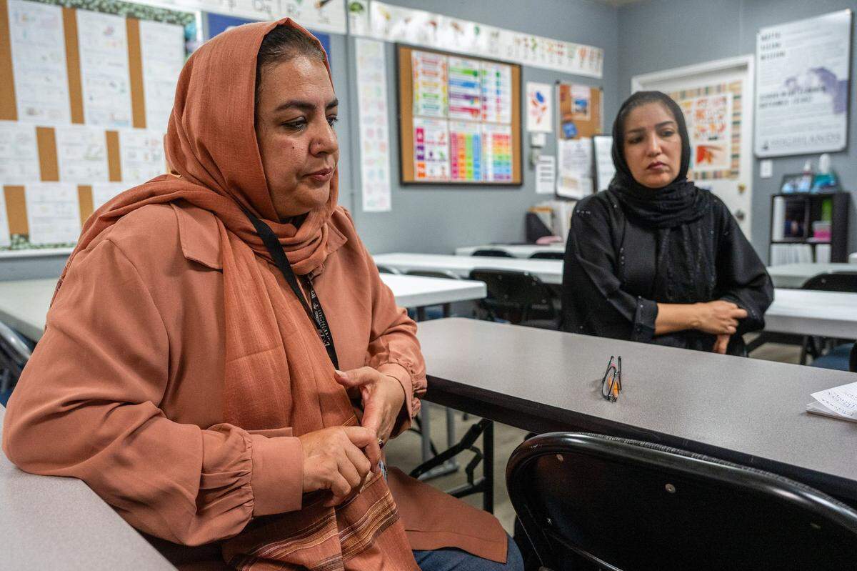 Paraeducator Nelofar Nasir, left, sits with student Dibi Bakhshi Kargar last month at their school in Arden Arcade. Both are concerned about the possible closure of the Highlands Community Charter and Technical School campus. Nasir said the school offers more than English classes – it connects students to vital community resources, including domestic violence support. She fears closures could isolate women by cutting off access to phones, bus passes and other critical services.