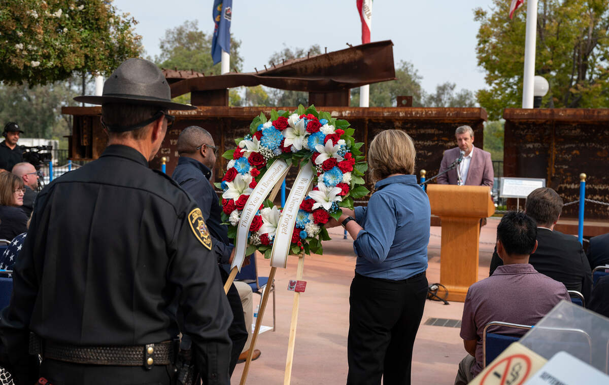 Veteran Tim Young and veteran spouse Dana Almora, both of Pride Industries, carry the memorial wreath forward followed by Cal Expo Police Chief Craig Walton during the Sunday ceremony remembering the events of 9/11 at Cal Expo’s September 11 Memorial Plaza.