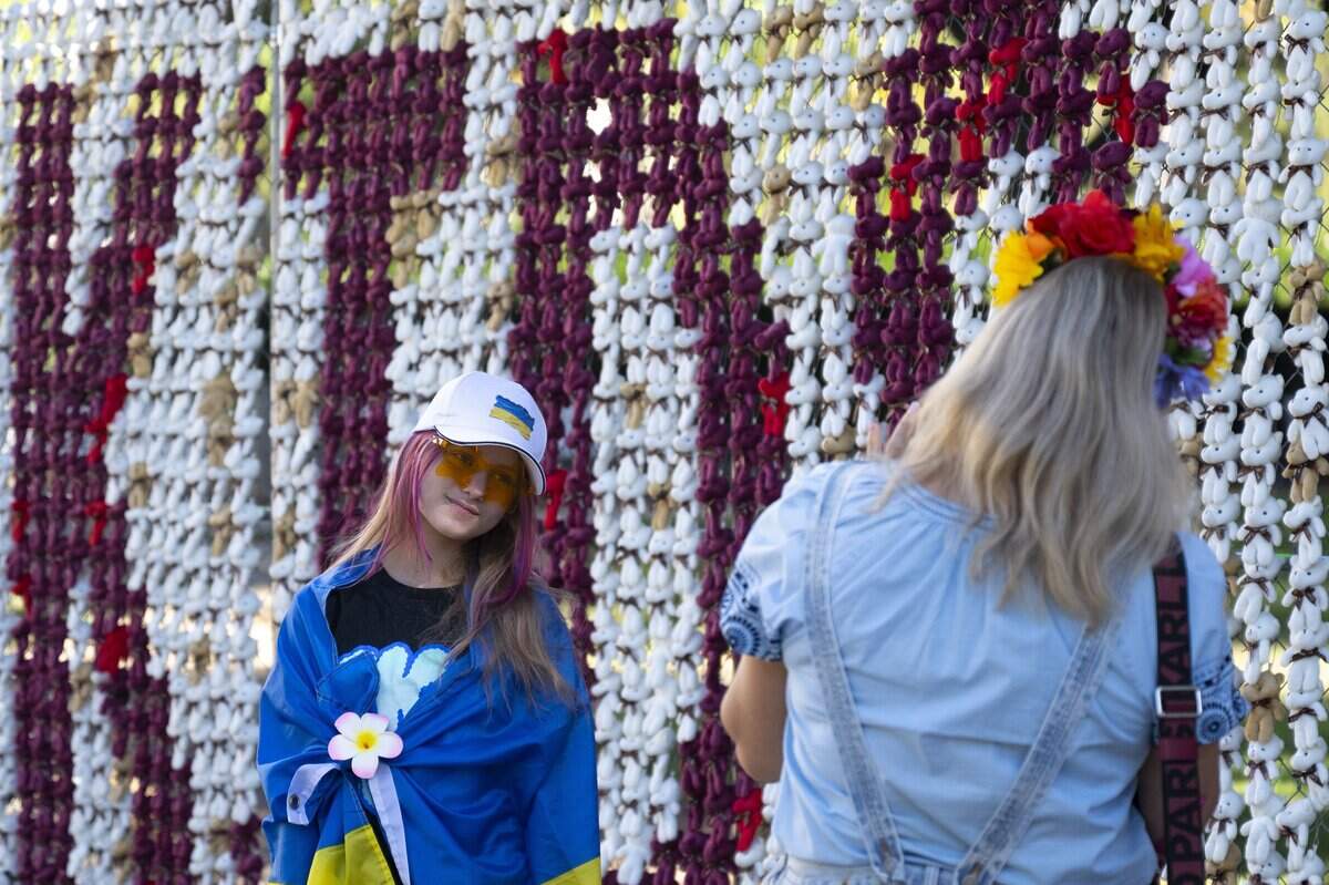 Galyna Shpilman photographs her daughter Arina in front of the “Bring Kids Back” installation, comprised of 20,000 teddy bears representing Ukrainian children who have been deported, forcibly transferred or separated from their families by Russia, in front of the state Capitol on Monday. The Shpilmans moved to the United States from Melitopol, Ukraine, and have lived in Sacramento for the past 3-1/2 years.