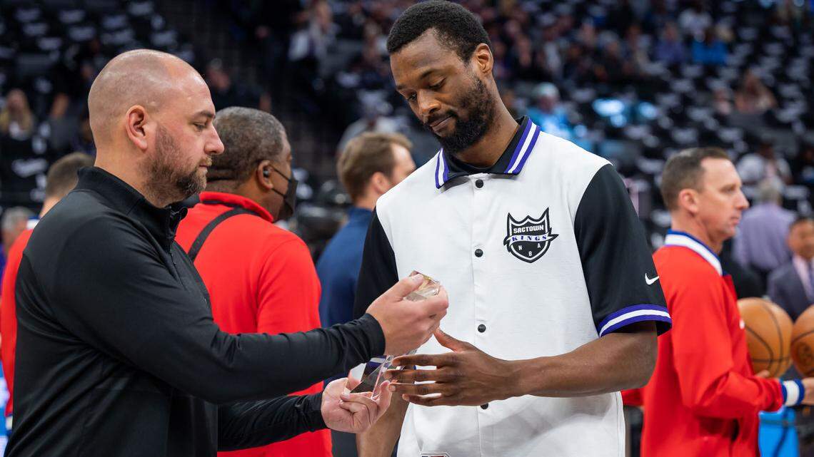 Sacramento Kings General Manager Monte McNair, left, hands the Oscar Robertson Triple-Double Award to forward Harrison Barnes (40) before their NBA basketball game against the New Orleans Pelicans on Tuesday, April 5, 2022, at Golden 1 Center in Sacramento. It was the last home game of the season for the Kings.