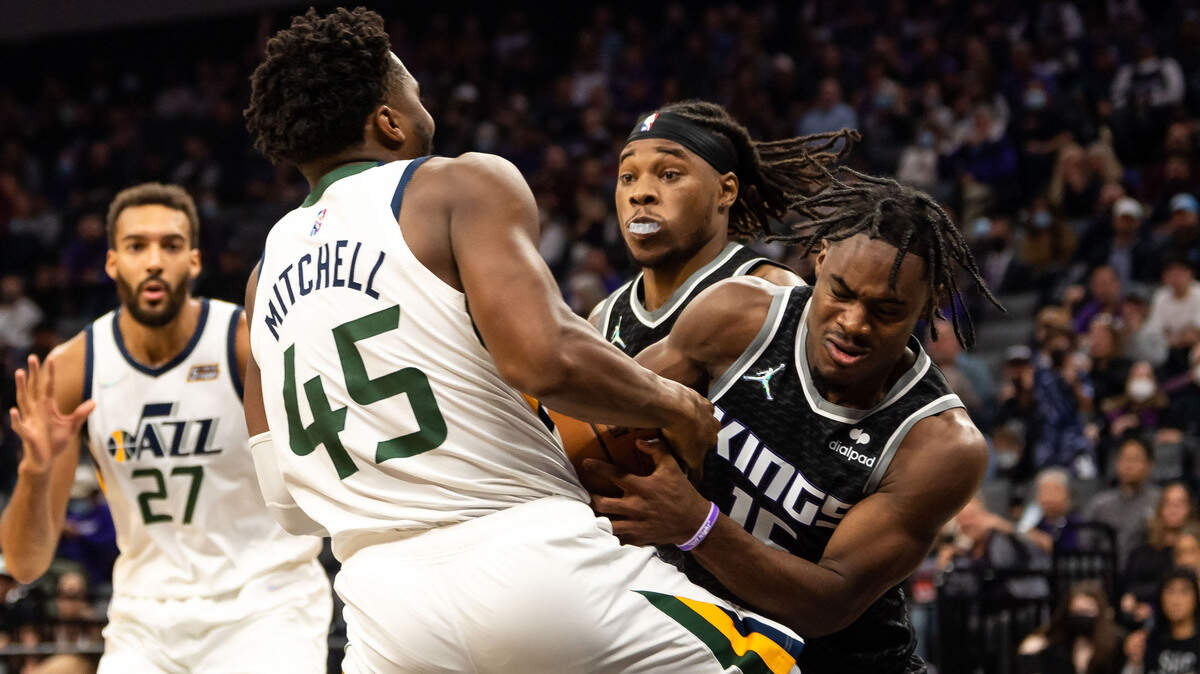 Sacramento Kings guard Davion Mitchell (15) wrestles the ball from Utah Jazz guard Donovan Mitchell (45) during the second period of their NBA regular season home opener Friday, Oct. 22, 2021, at Golden 1 Center in downtown Sacramento.