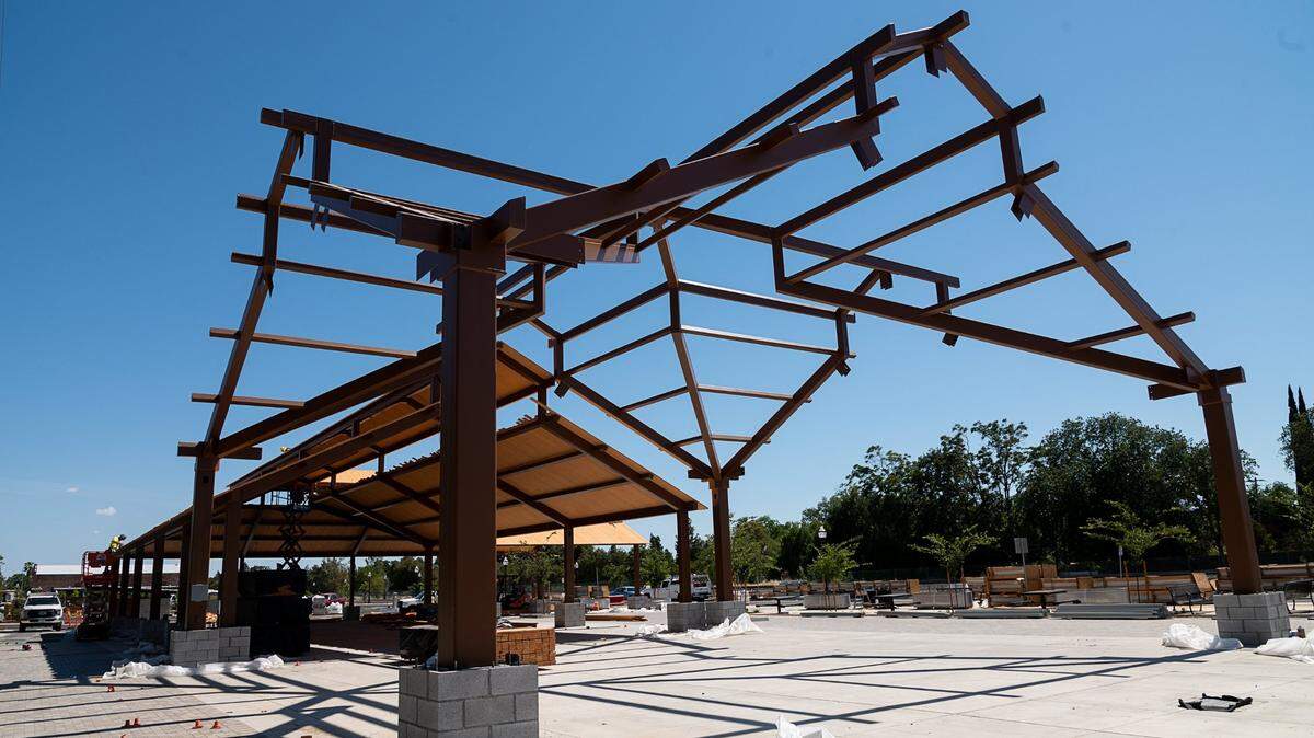 Work under way at Old Town Plaza on Railroad Street in Elk Grove’s historic downtown Tuesday, June 8, 2021. The pavilion structure, now completed, will be the centerpiece of a community gathering space that will be enhanced by the relocation of a new library two blocks away..