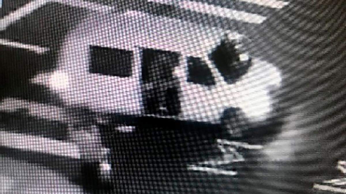 This May 29, 2020, surveillance photo provided by the FBI shows a van with the passenger side door open as someone fires at a security kiosk at the Ronald V. Dellums Federal Building in Oakland, Calif. Robert Alvin Justus Jr. is accused of being the driver of the van from which U.S. Air Force Staff Sgt. Steven Carrillo allegedly shot and killed federal officer Dave Patrick Underwood, 53, and wounded of another officer in the incident. (FBI via AP)