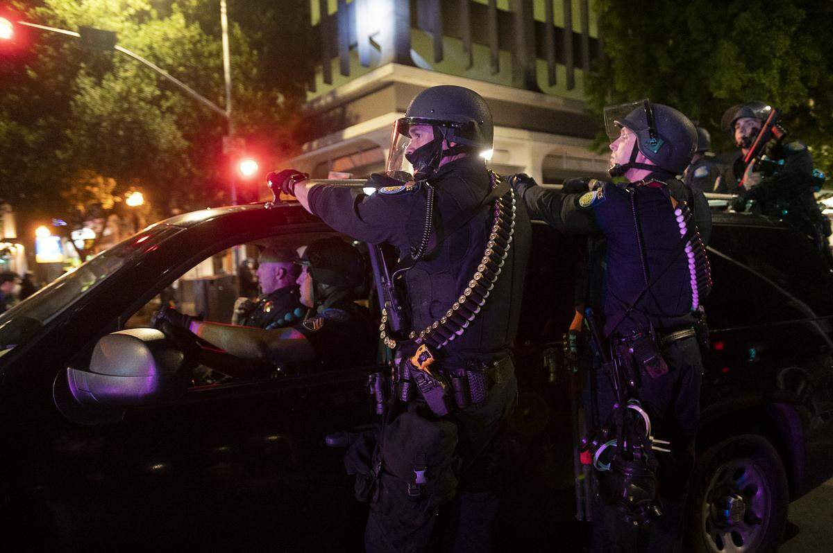 Sacramento Police officers deploy to another area during a protest on Sunday over the death of George Floyd, who died in Minneapolis on May 25 after being detained by police.