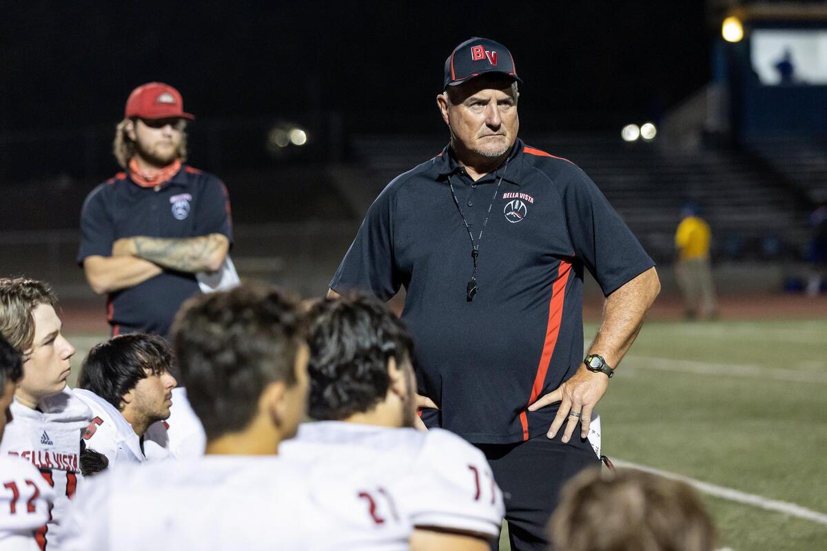 Bella Vista coach Jim Gray speaks with his team after a 2022 game against the Del Campo Cougars. Gray is one of several Sacramento-area coaches resigning to spend more time with family.