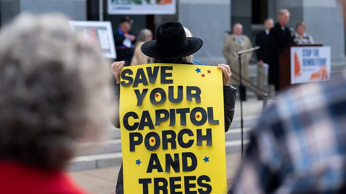 Patty Gregor holds sign protesting the Capitol Annex project on Wednesday, November 17, 2021, at the state Capitol. About 50 people joined the demonstration against the demolition of the east wing of the statehouse, which would require the removal of a number of important trees in Capitol Park.