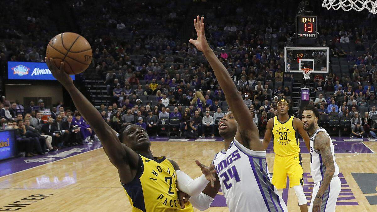 Indiana Pacers guard Darren Collison, left, goes to the basket against Sacramento Kings guard Buddy Hield during the first half of an NBA basketball game, Saturday, Dec. 1, 2018, in Sacramento, Calif. The Kings won 111-110. (AP Photo/Rich Pedroncelli)