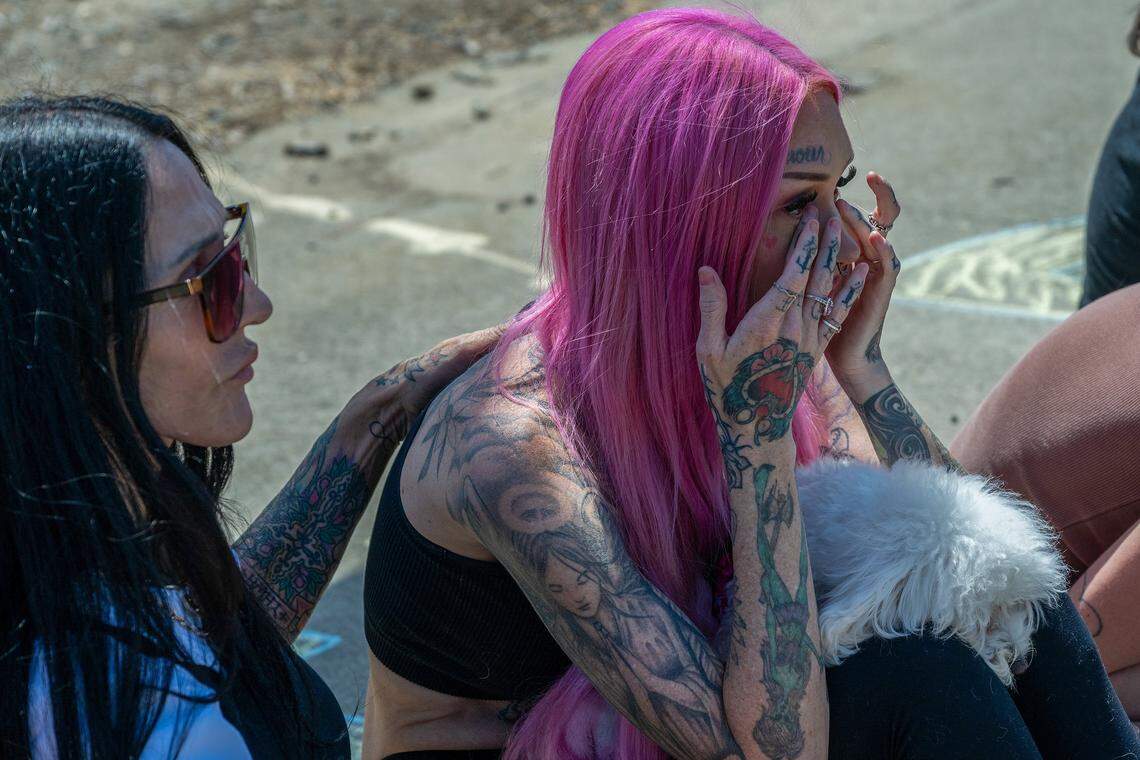 Erika Pringle wipes away tears after hearing an emergency vehicle siren near the spot where her brother, Andrew Pringle, was struck and killed by a car two years earlier, as she gathers with friends for a memorial on April 23, near the intersection of Folsom Boulevard and Manlove Road in Rosemont.