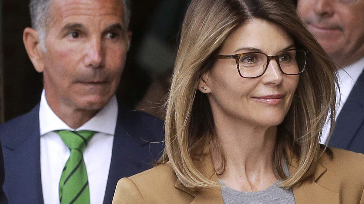 FILE - In this April 3, 2019 file photo, actress Lori Loughlin, front, and husband, clothing designer Mossimo Giannulli, left, depart federal court in Boston after facing charges in a nationwide college admissions bribery scandal. On Tuesday, April 9, Loughlin and Giannulli were among 16 prominent parents indicted on an additional charge of money laundering conspiracy in the case. (AP Photo/Steven Senne, File)