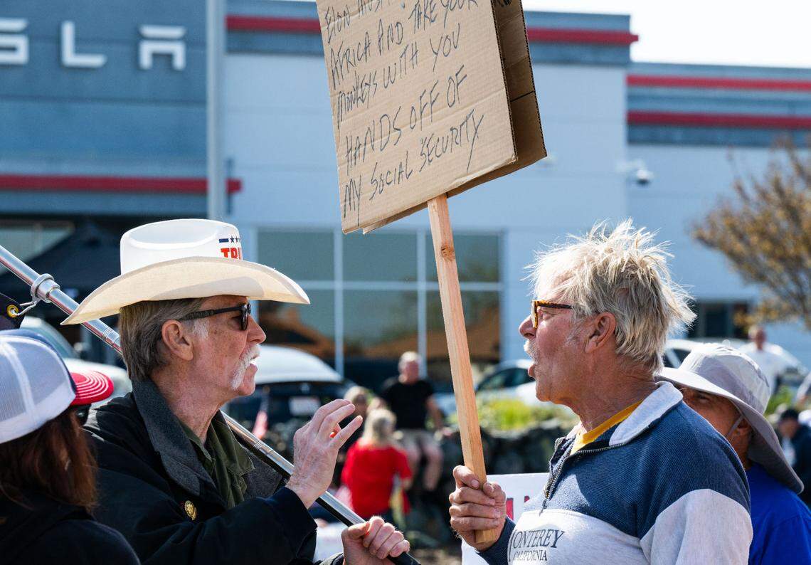 A Trump counter protestor, left, and a anti-Tesla demonstrator argue in front of the Tesla dealership on Granite Drive in Rocklin on Saturday, March 29, 2025.
