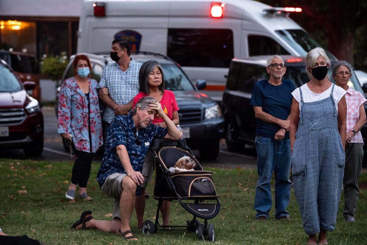 Family, friends and area residents mourn during a vigil for Kate Tibbitts at Plaza Cervantes Park on Thursday, Sept. 9, 2021, in Sacramento’s Land Park neighborhood. Tibbitts and her two dogs, Molly and Ginny, where found slain in their 11th Avenue home on Sept. 3.
