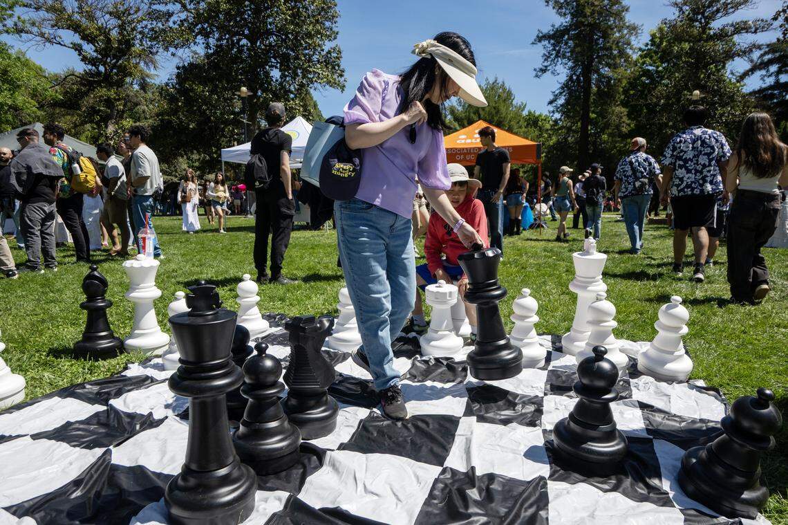 UC Davis alumni Miranda Zhu plays chess with her son Anthony on the UC Davis campus during Picnic Day on Saturday.