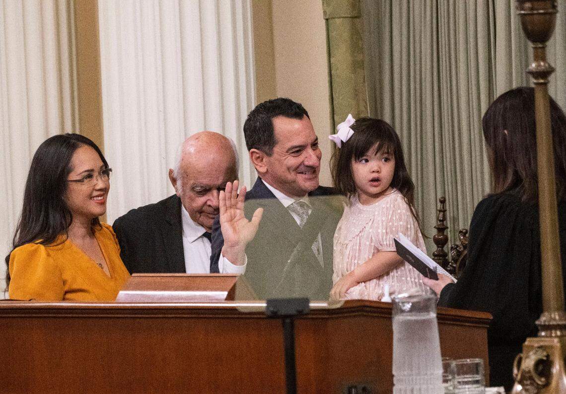Assembly Speaker Anthony Rendon is sworn in by California Supreme Court Justice Patricia Guerrero during the Assembly organizational session on Monday, Dec. 5, 2022 at the state Capitol. Rendon holds daughter Annie Rendon, 3, and was joined by wife Annie Lam and his father Tom Rendon.