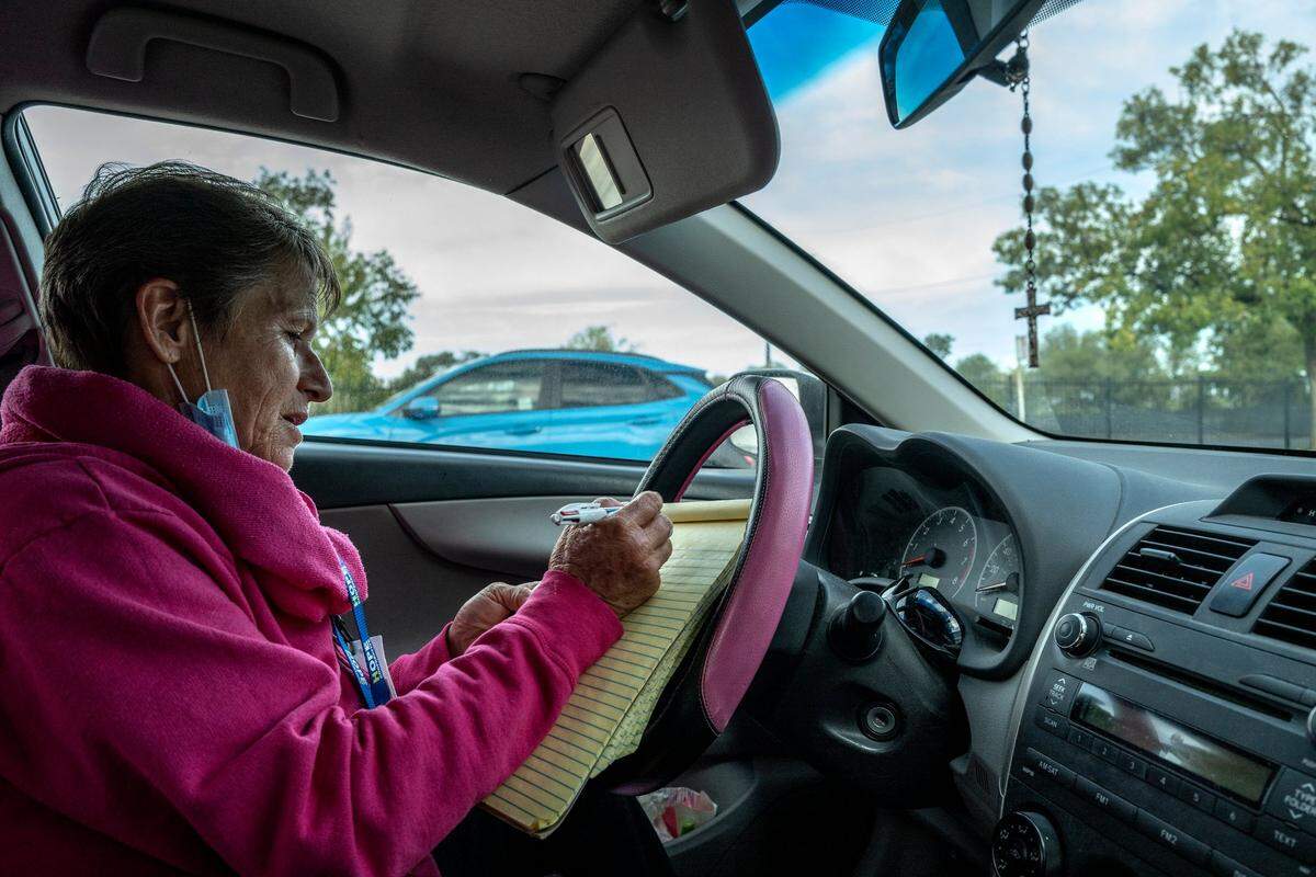 Tracey Knickerbocker, 61, case manager for Hope Cooperative, sits in her car as gets ready to visit homeless clients off a wooded path on Colfax Street near Arden Way in Sacramento on Sept. 20.