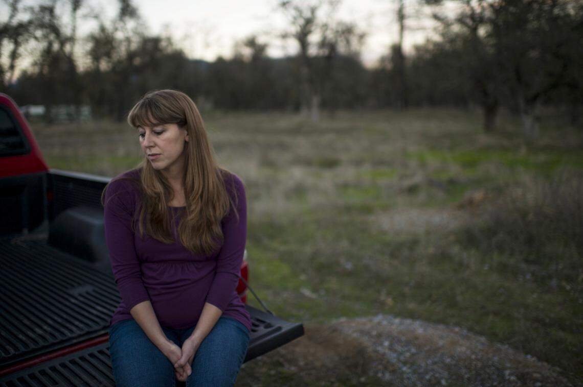 Sherri Papini’s sister, Sheila Koester, sits on a pickup’s tailgate in November 2016, near the location of where her sister went missing earlier in the month.