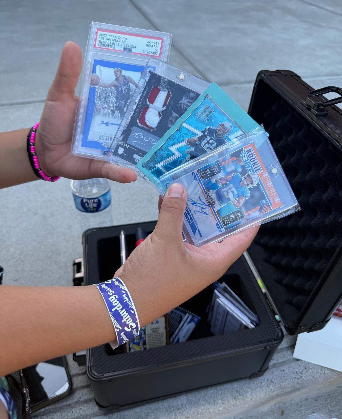 Niko Valdivia, 12, holds some of the cards he purchased and was looking to sell at the annual Sacramento Autograph and Sports Card Expo at the Grounds in Roseville on Sept. 27.
