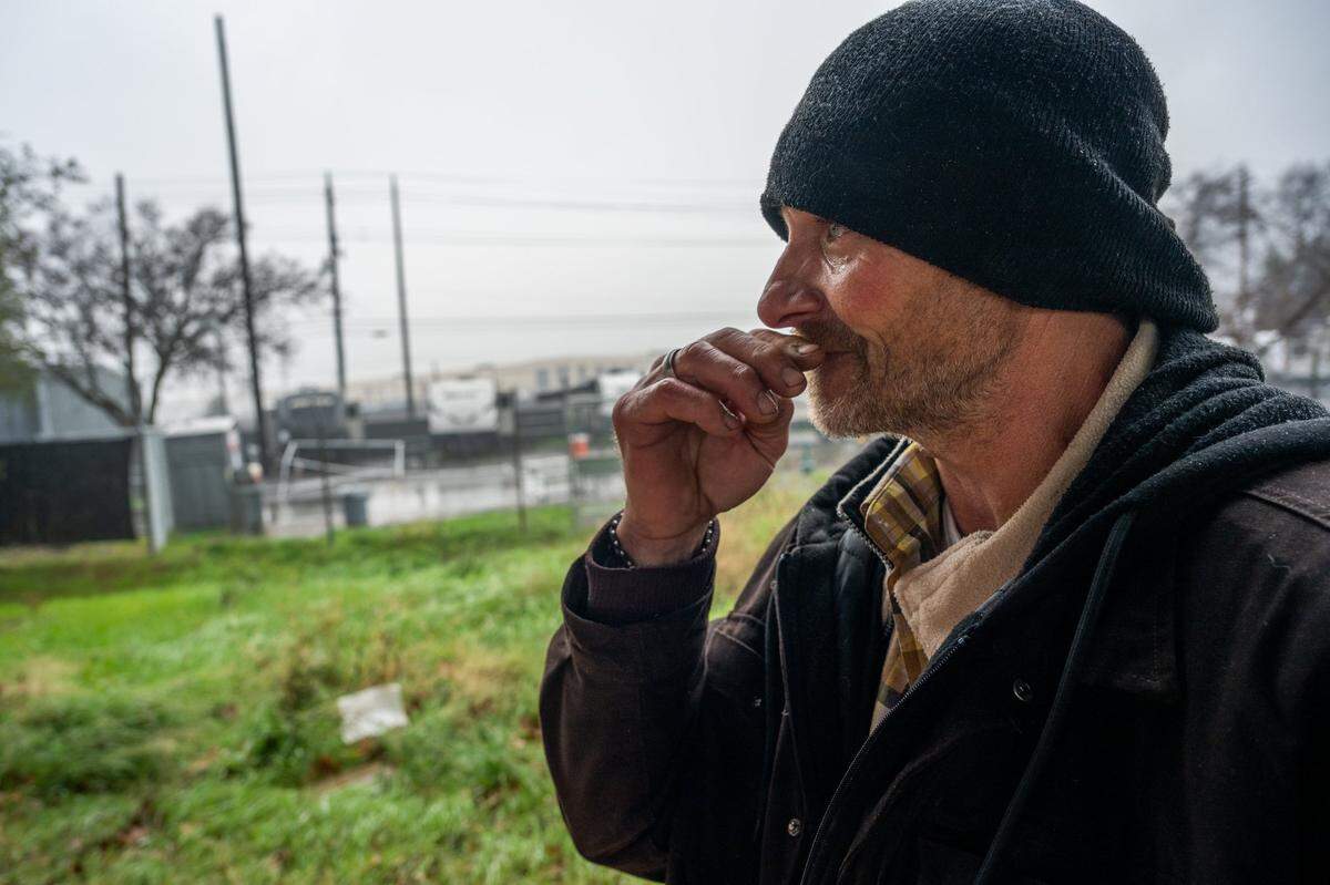 Tears stream down the face of Phillip Minton, as he talks earlier this month about the death of his partner Wendy Connell while he stands in the light rail parking lot and looks at the travel trailer he shared with her in Sacramento’s Roseville Road shelter. He said that her death might have been avoided if residents had been allowed to use the shelter property’s back gate.