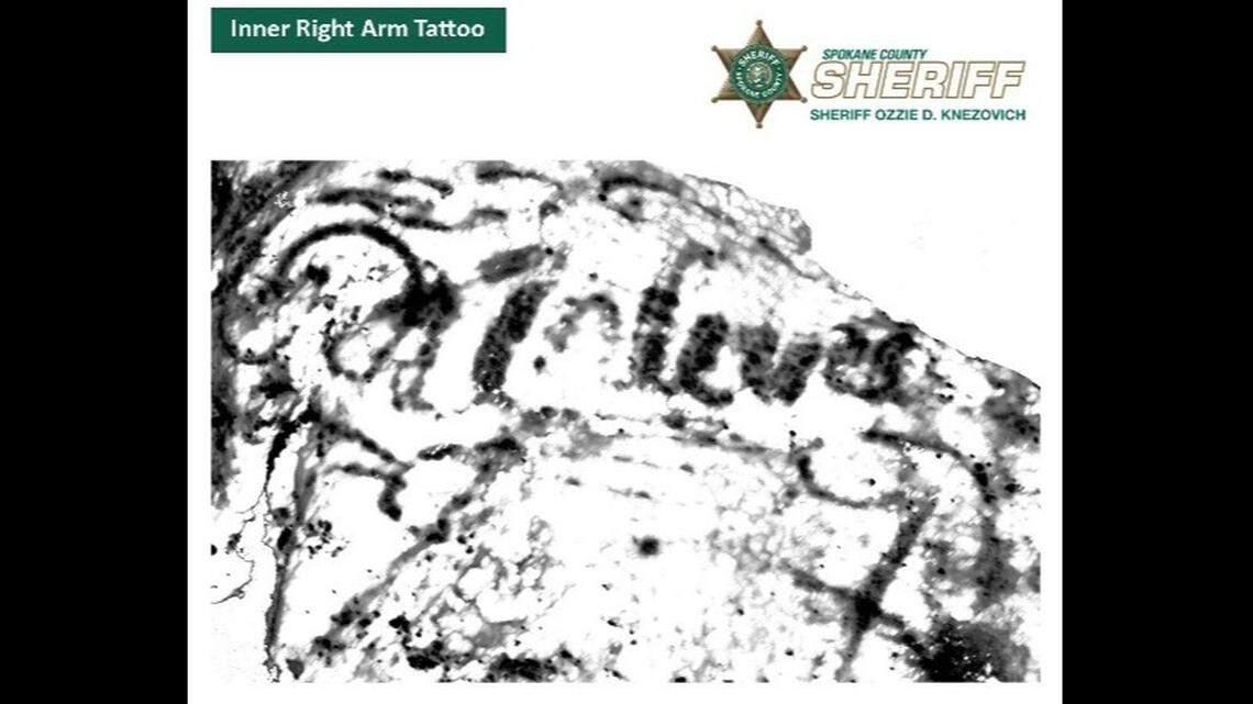 Tattoo on inner-right arm/shoulder with writing.