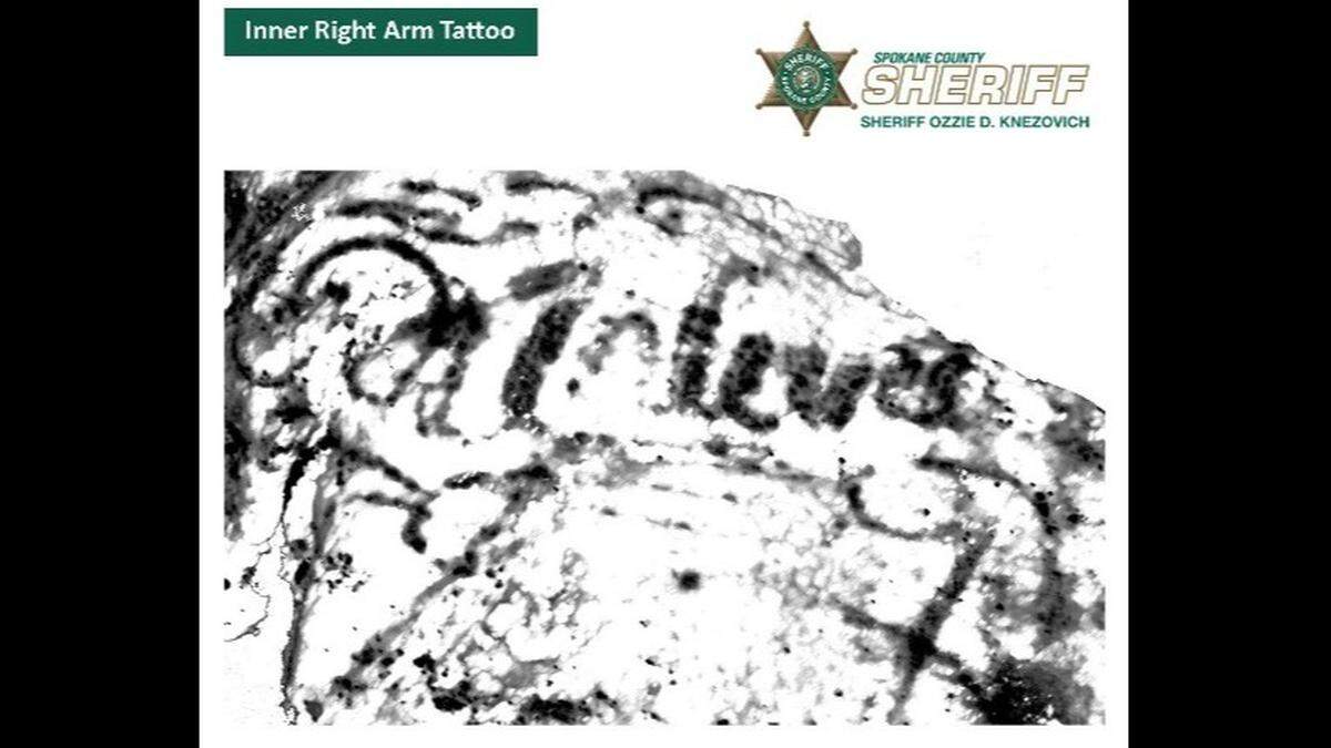 Tattoo on inner-right arm/shoulder with writing.