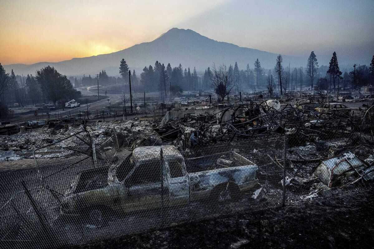 The sun rises over Mount Shasta and homes in Weed destroyed by the Mill Fire in September 2022. Pacific Bell is suing a timber company that operated a mill in Weed, where the deadly 2022 Mill Fire erupted.