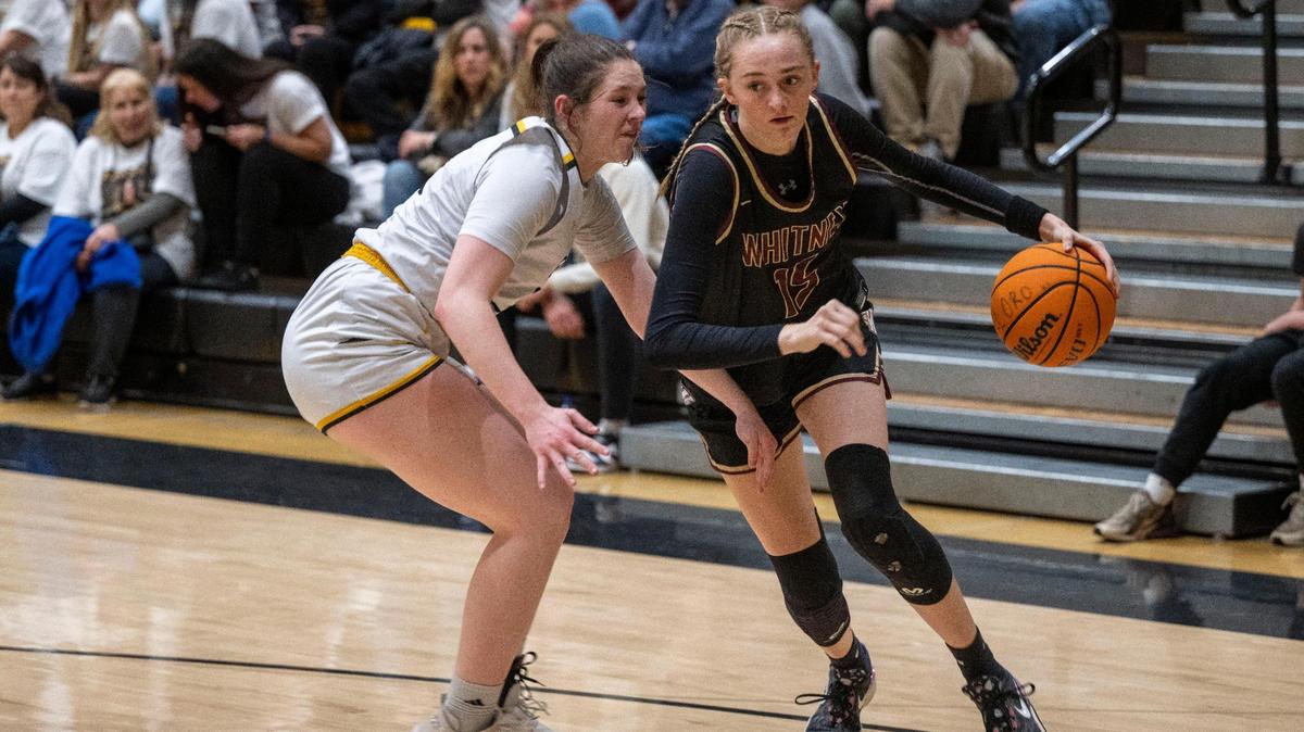Whitney High School’s Harper Peterson, right, drives past Del Oro’s Sidney Somer in a game Friday in Loomis.