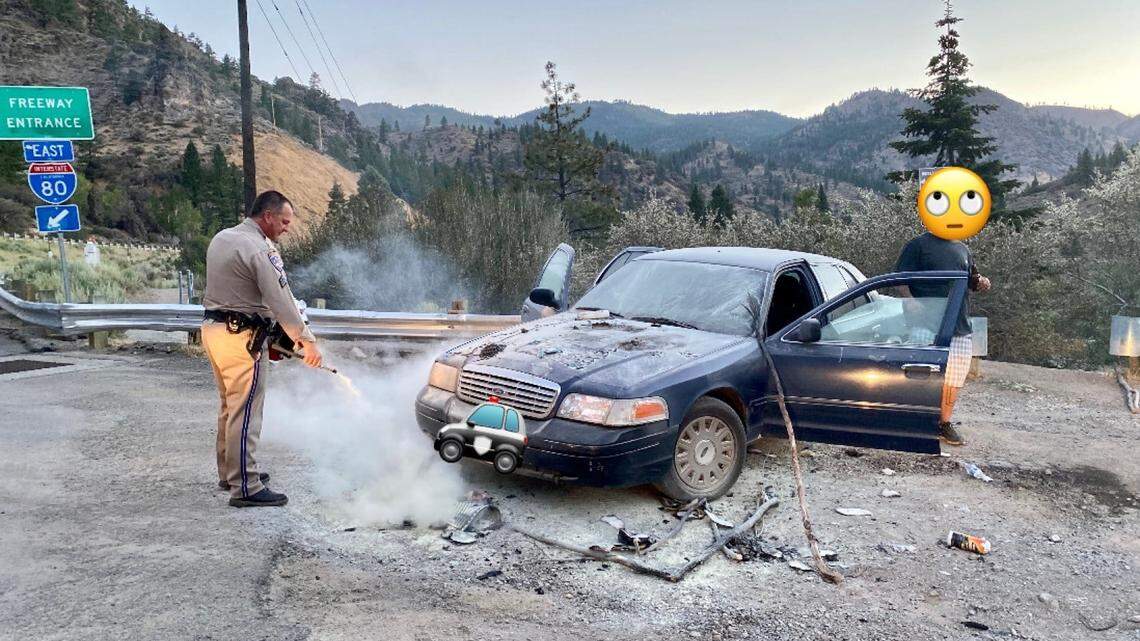 A CHP official douses a car fire that began alongside Interstate 80 in Truckee on July 15, 2021. CHP reports that the man set the fire to try to scare away bears.